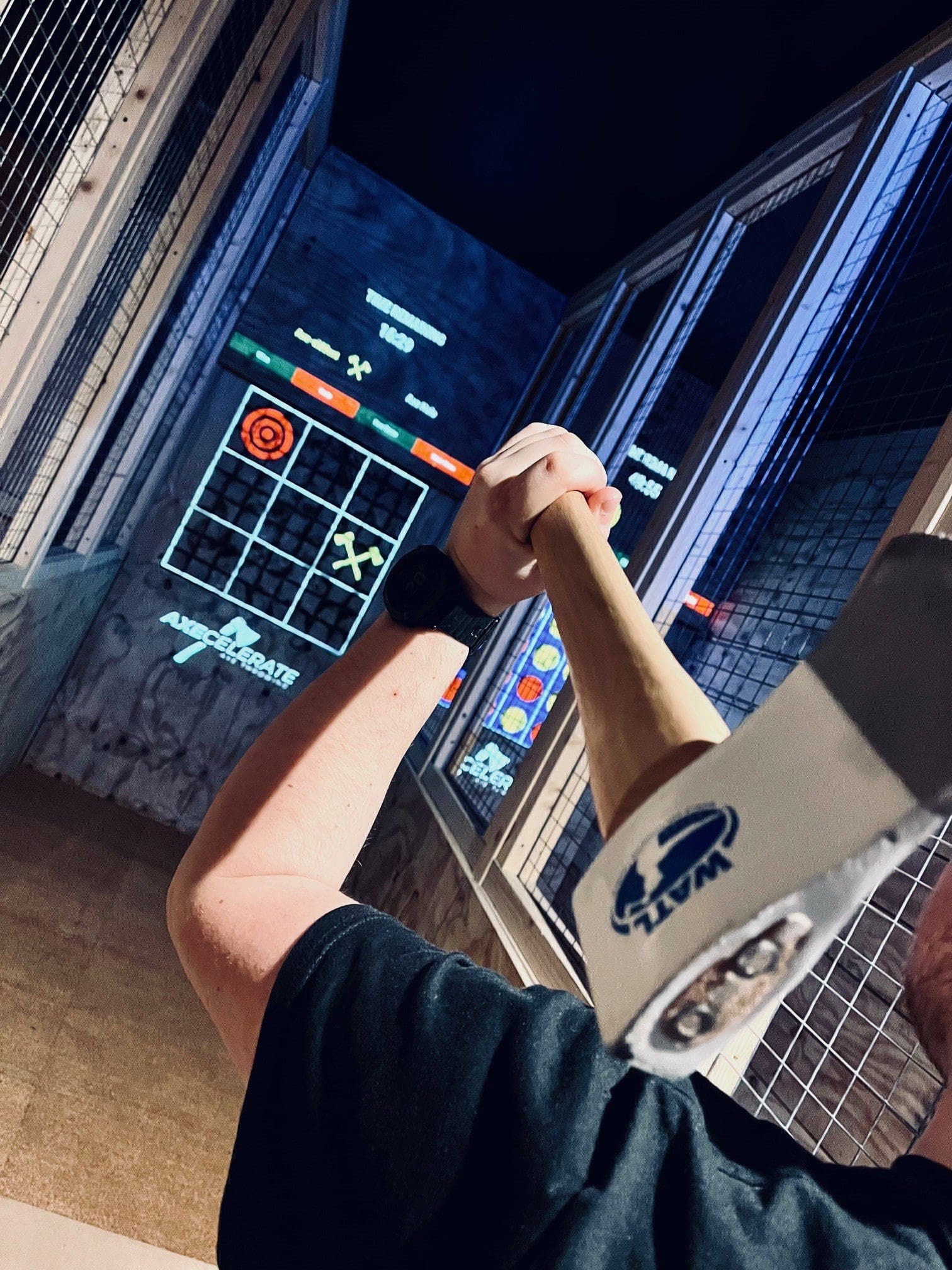 A competition axe about to be thrown at a projected target at Axecelerate indoor axe throwing in Milton Keynes