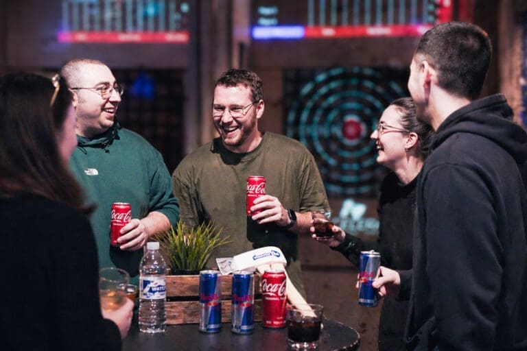 Group in Axecelerate indoor axe throwing drinking during an Axe Plus event